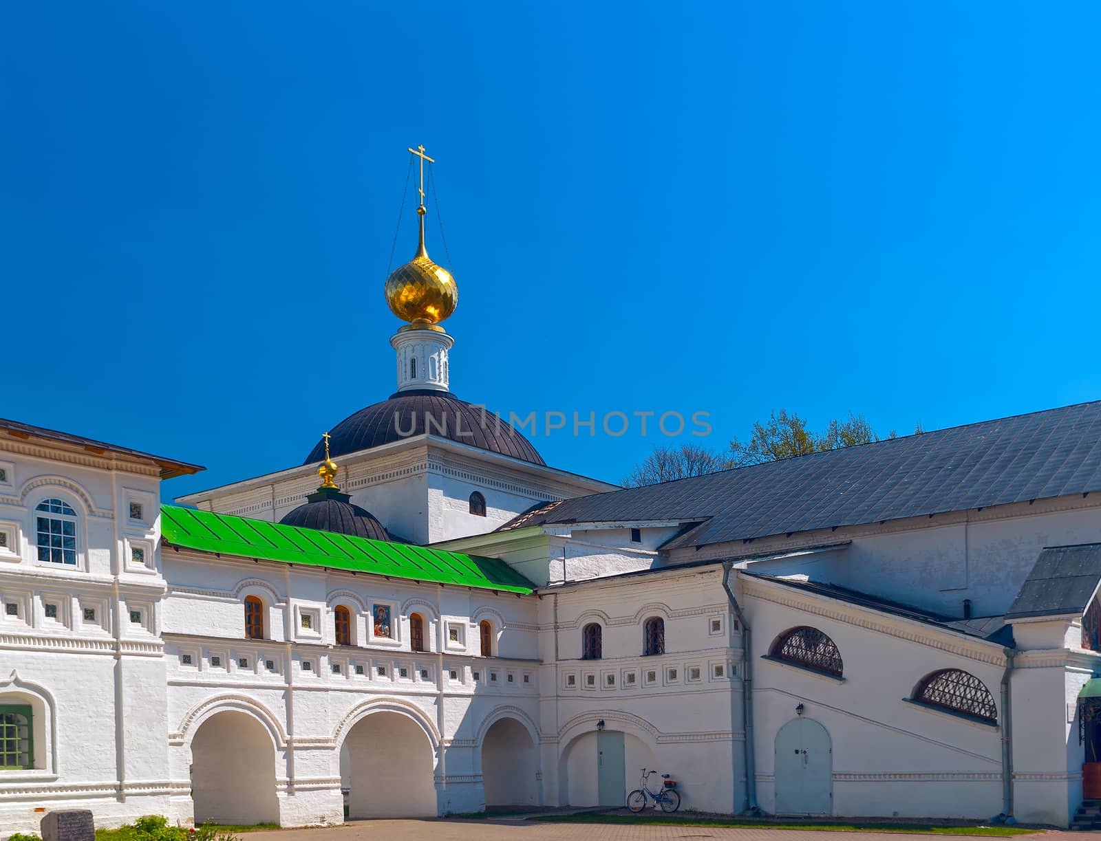 Courtyard white orthodox monastery with bicycle