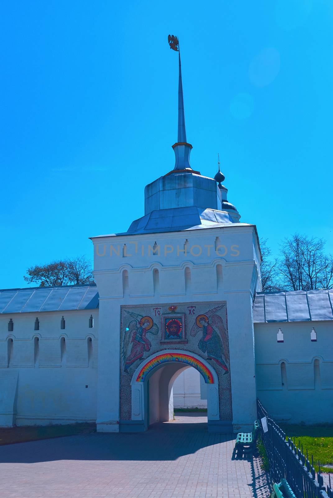 Entrance gate to the white orthodox monastery with the icon of Christ and the angels