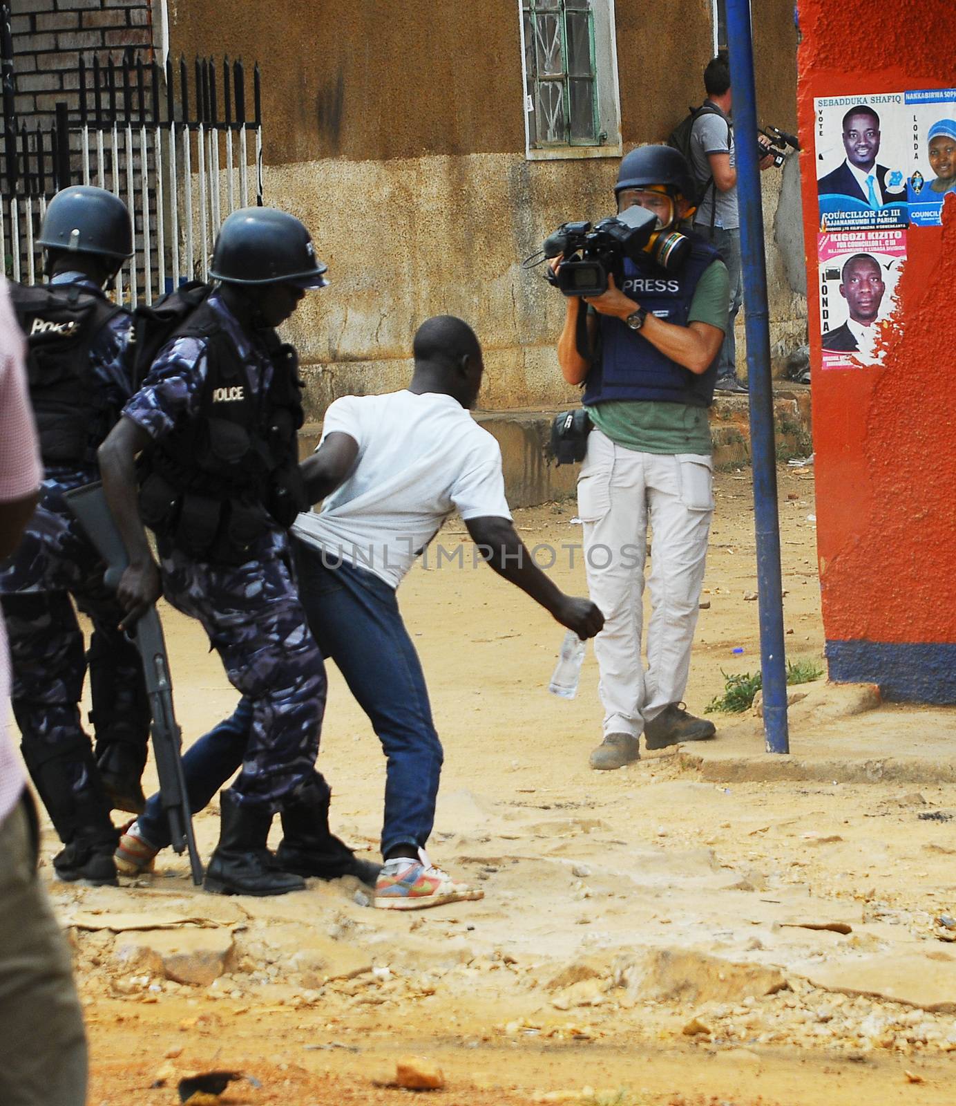 UGANDA, Kampala: Riot police arrest a supporter of presidential candidate Kiiza Besigye at his party headquarters just after Besigye himself was arrested in Kampala, Uganda on February 19, 2016 so as to prevent him from announcing his own results for the day's elections.