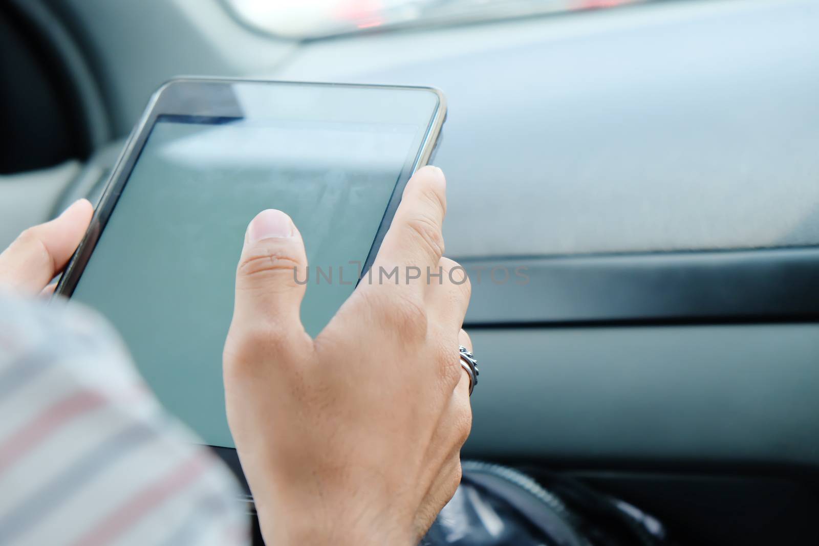 image of using a digital tablet inside of a car. communication technology background