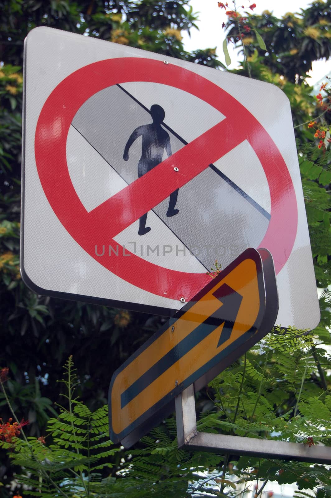 Prohibiting pedestrian road sign with arrow symbol, Singapore