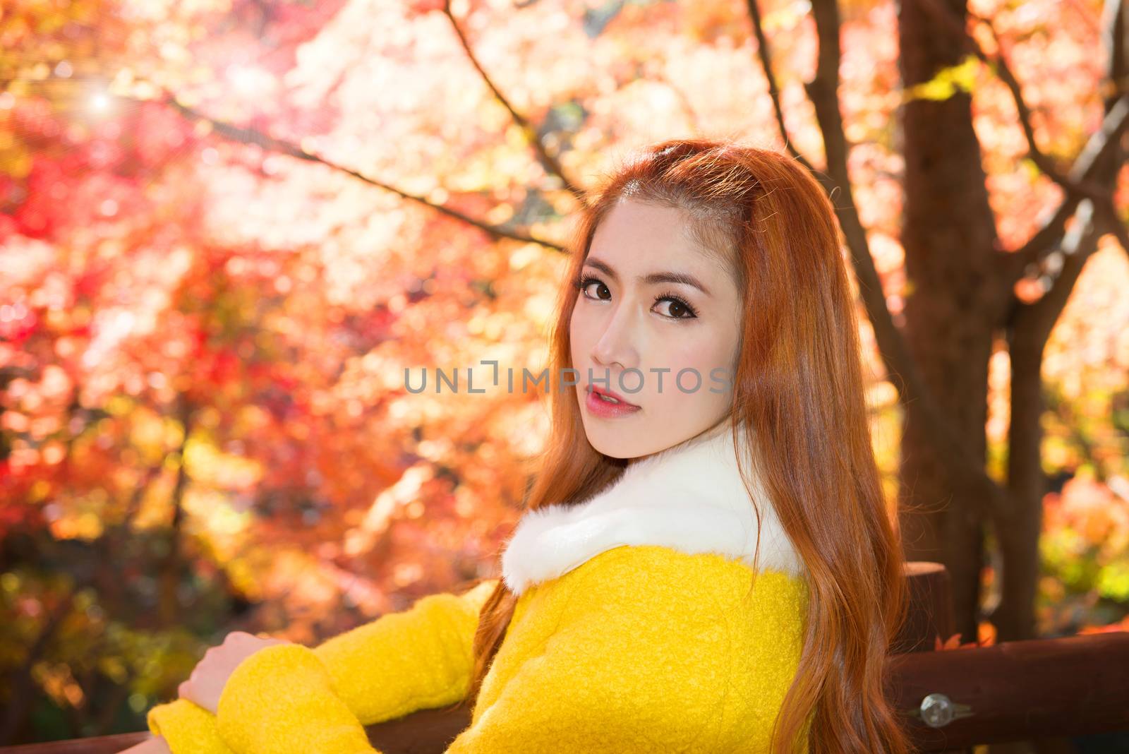 Young woman with autumn leaves in maple garden. by gutarphotoghaphy