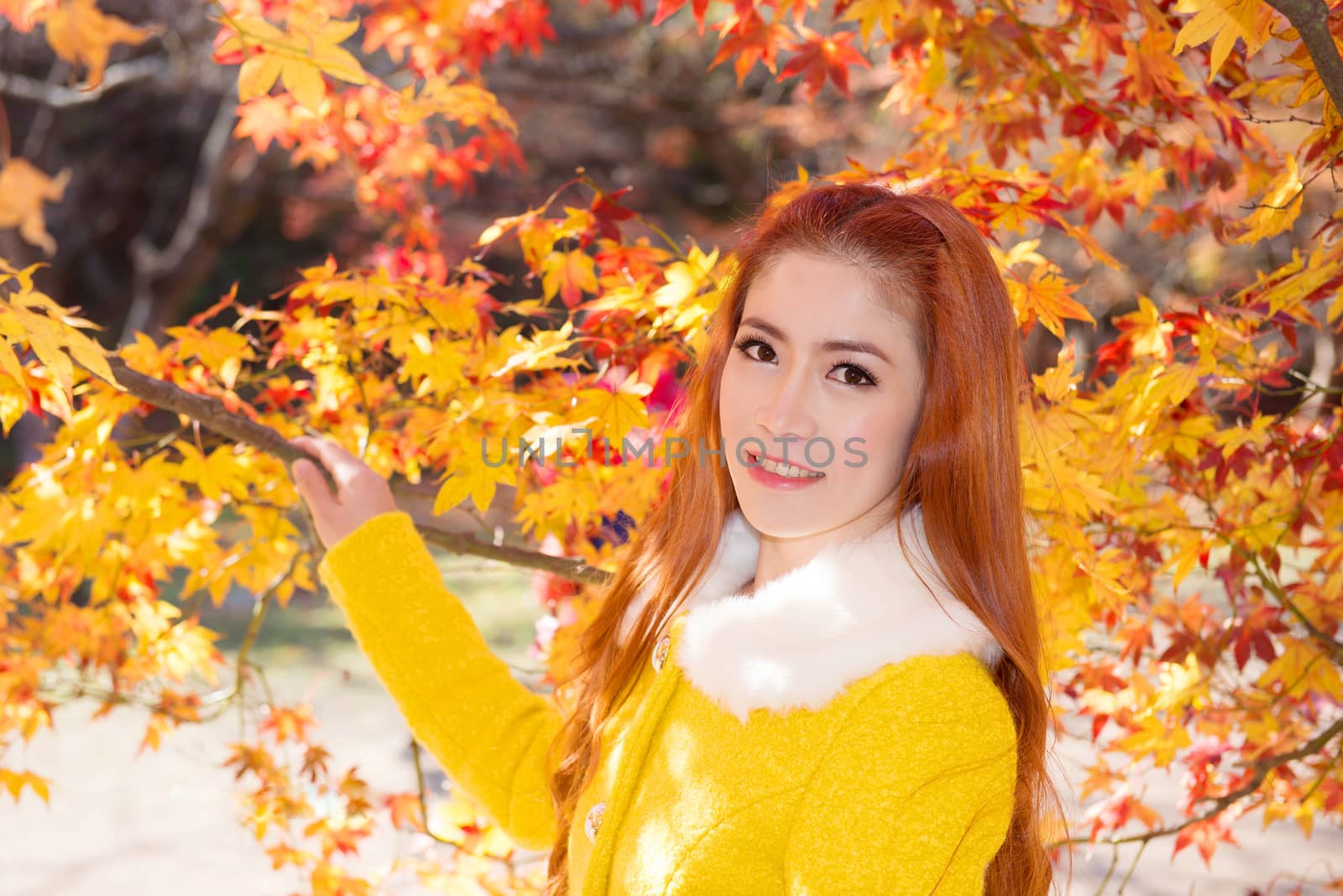 Young woman with autumn leaves in maple garden. by gutarphotoghaphy