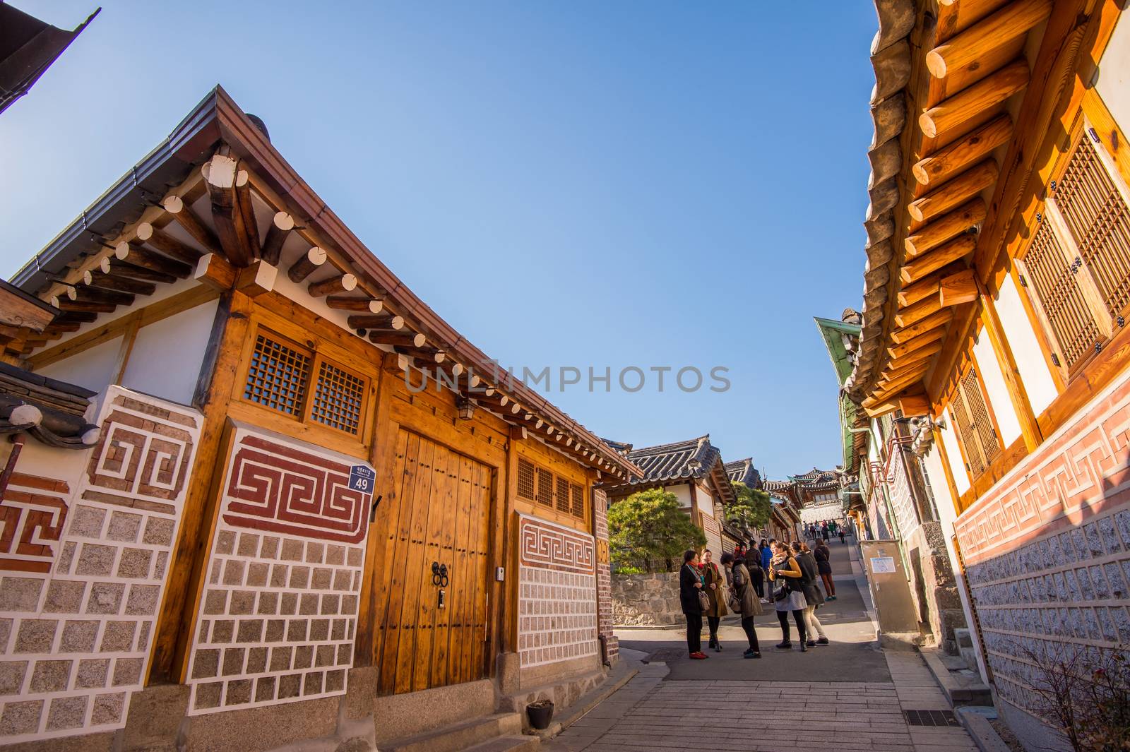 Tourists taking photos of the beautiful scenery around Bukchon Hanok Village,Traditional Korean style architecture. by gutarphotoghaphy