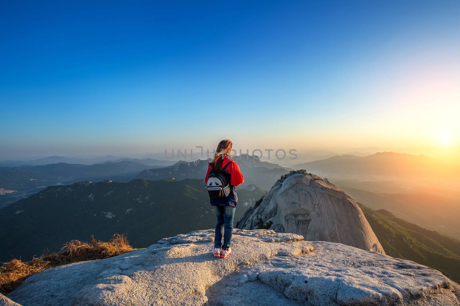 Woman stands on the peak of stone in Bukhansan national park,Seo by gutarphotoghaphy