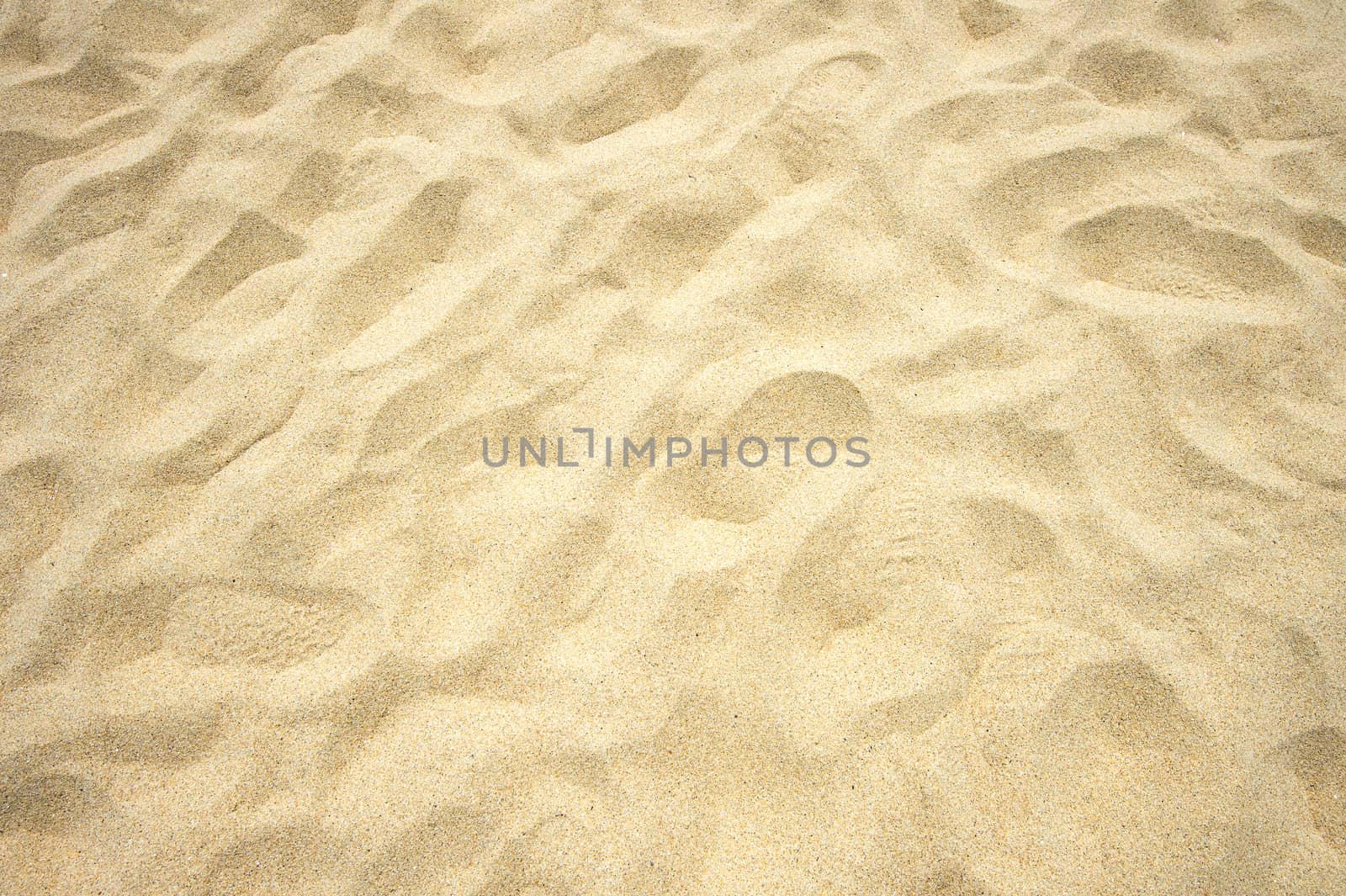 Footmarks on sand background