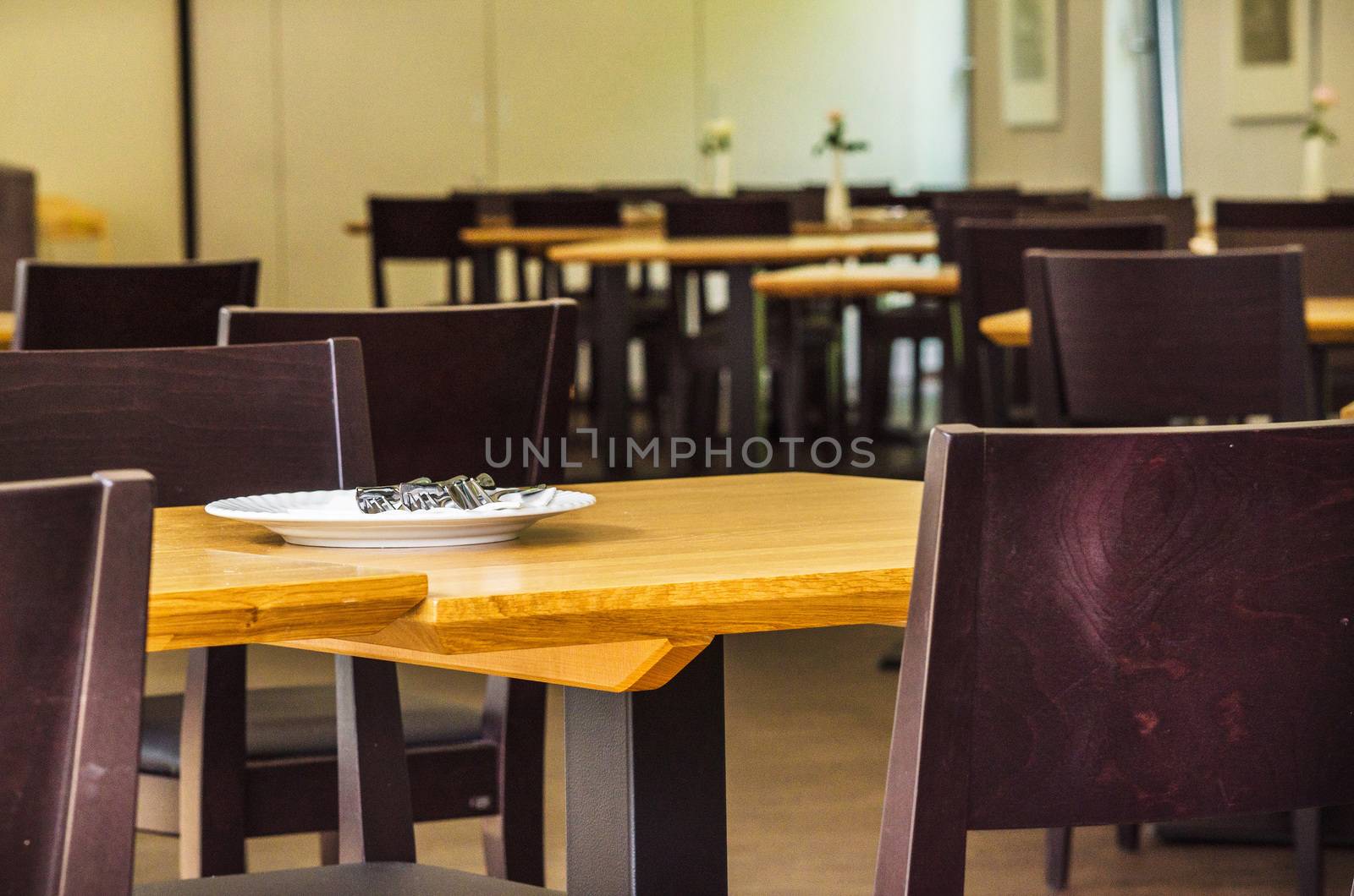 Tables and chairs in a restaurant. by JFsPic