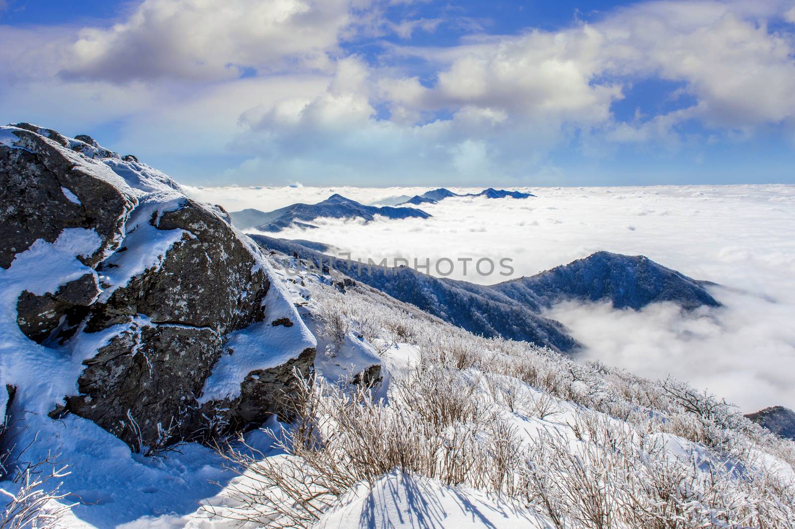 Seoraksan mountains is covered by morning fog in winter, Korea. by gutarphotoghaphy