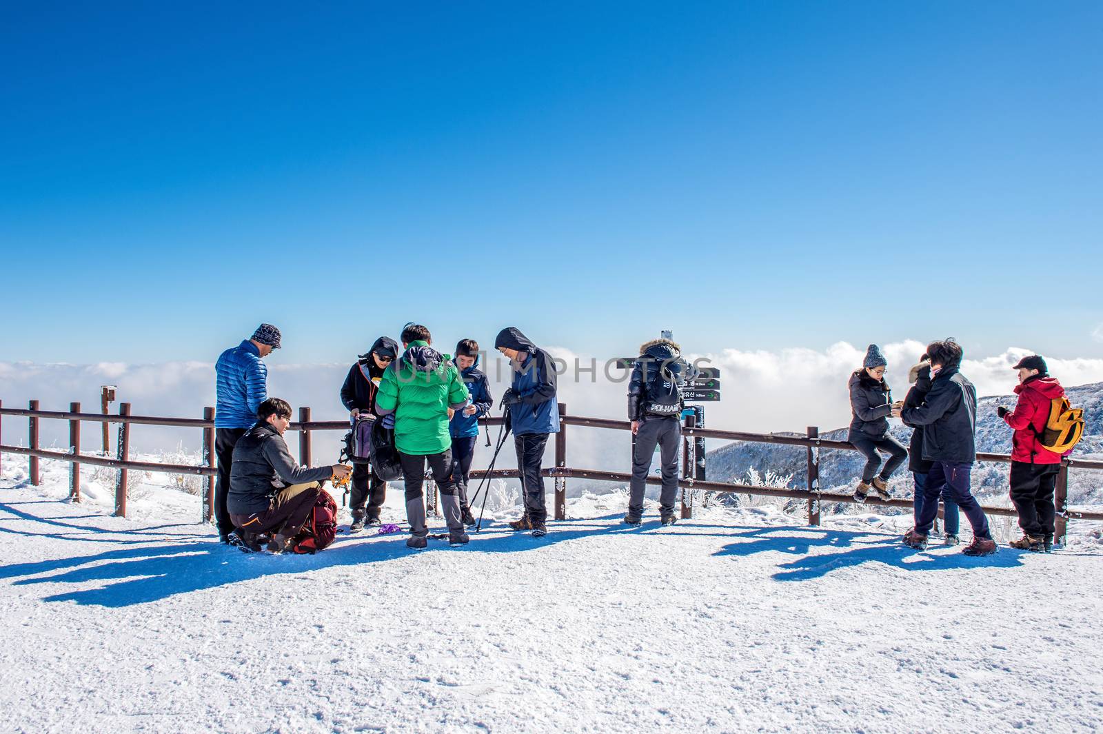 DEOGYUSAN,KOREA - JANUARY 23: Tourists taking photos of the beautiful scenery and skiing around Deogyusan,South Korea on January 23, 2015.