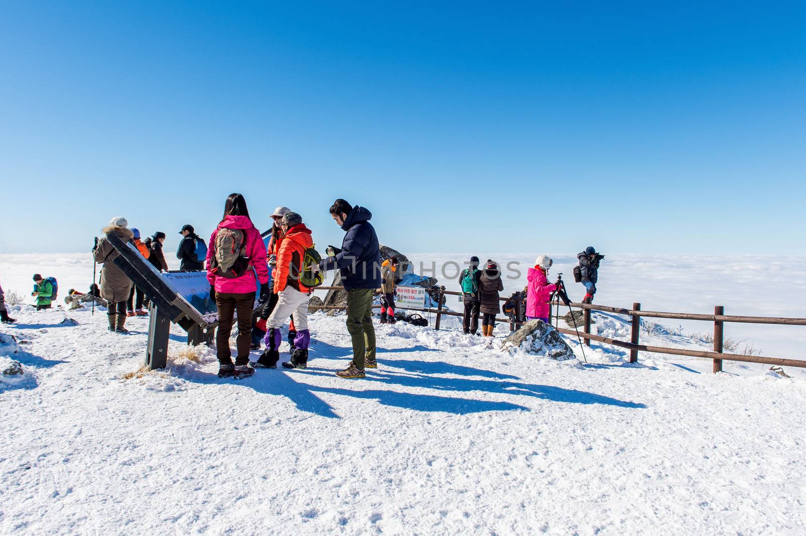 DEOGYUSAN,KOREA - JANUARY 23: Tourists taking photos of the beautiful scenery and skiing around Deogyusan,South Korea on January 23, 2015.