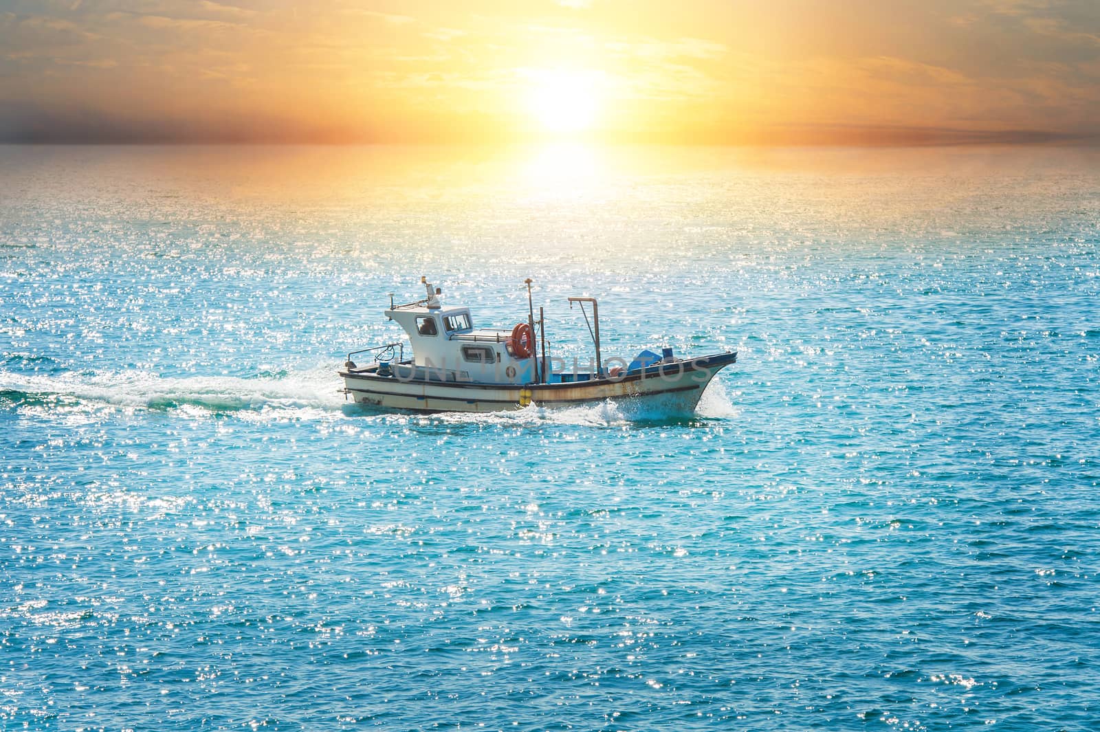 fishing boat in sea at sunset