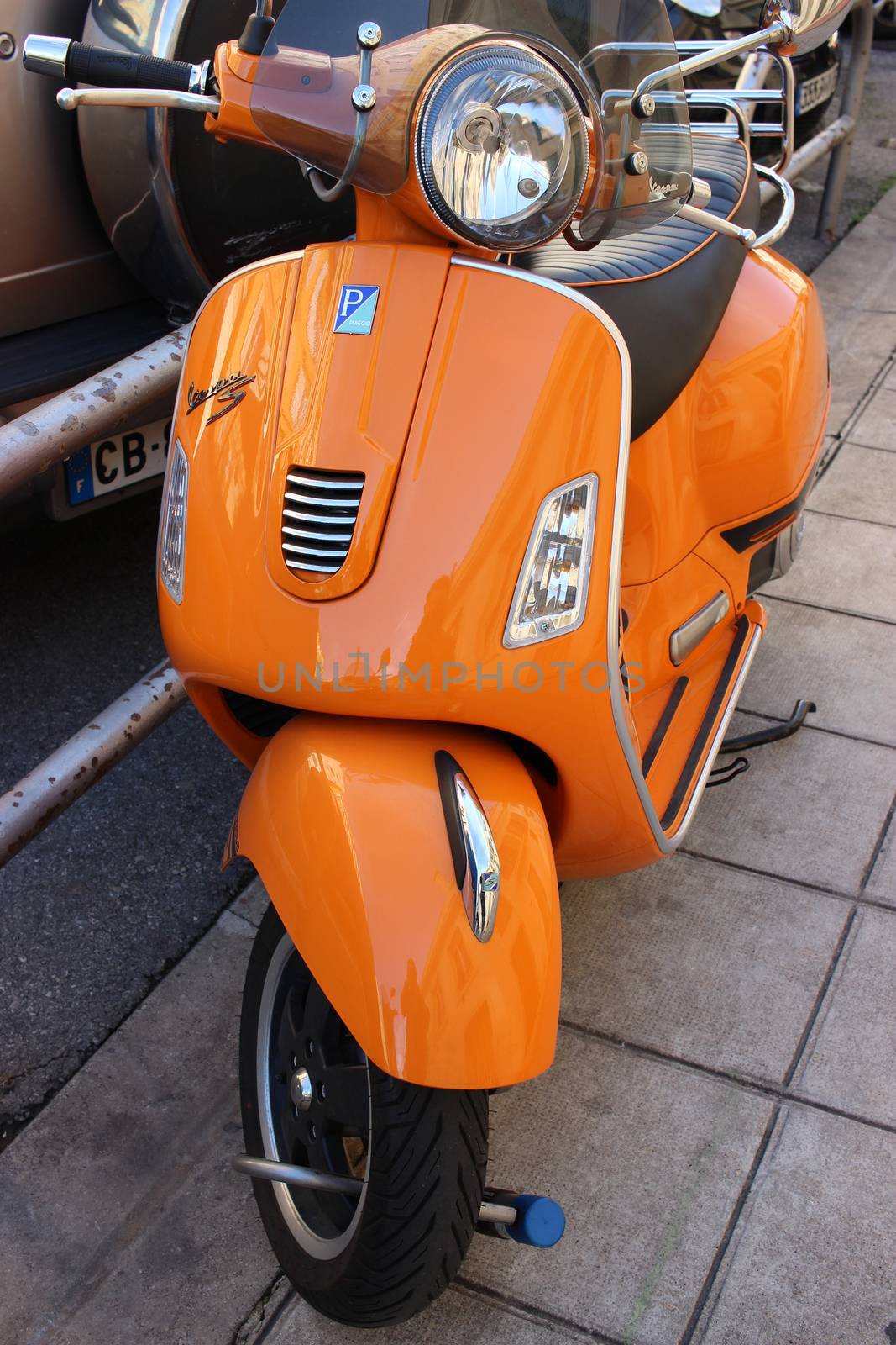 Nice, France - February 15 2016: Classic Orange Scooter Vespa S Piaggio 125 cm3 parked on street at Nice, France