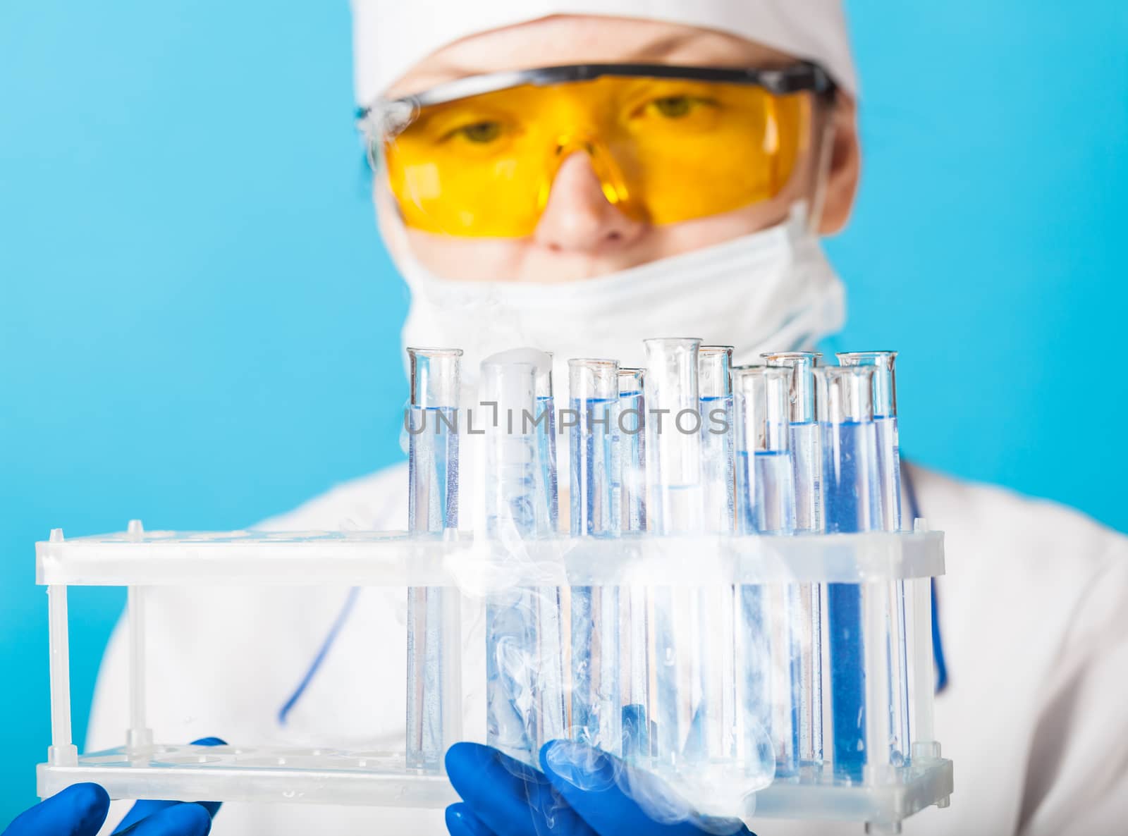 Woman chemist examines test tube  by MegaArt