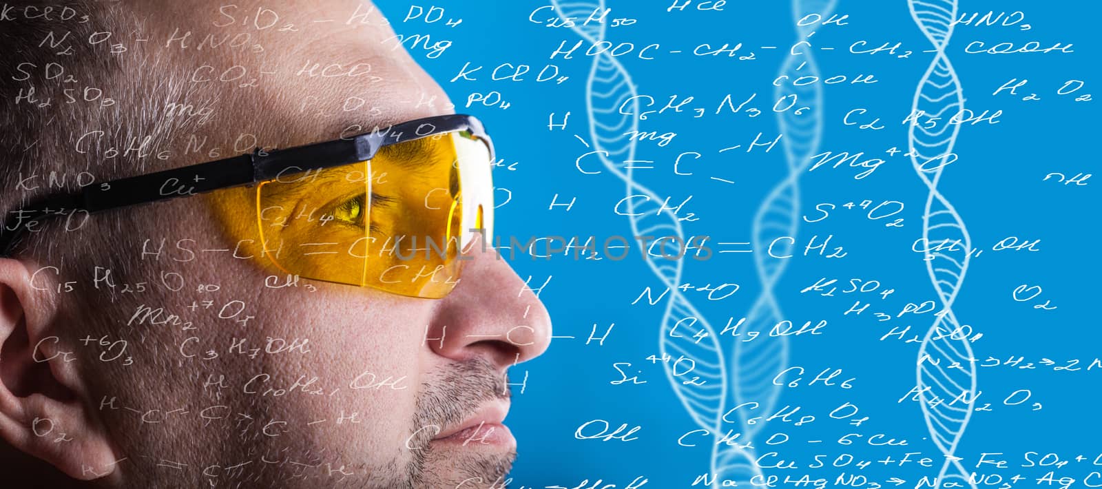 man in glasses working on a blue background