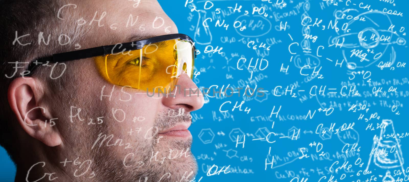 man in glasses working on a blue background