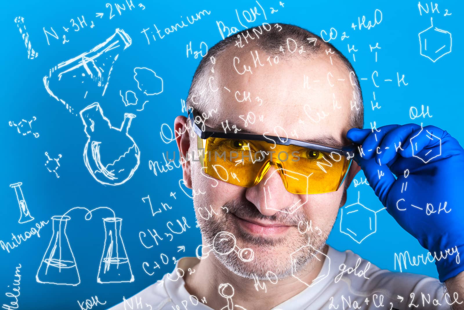 man in glasses working on a blue background