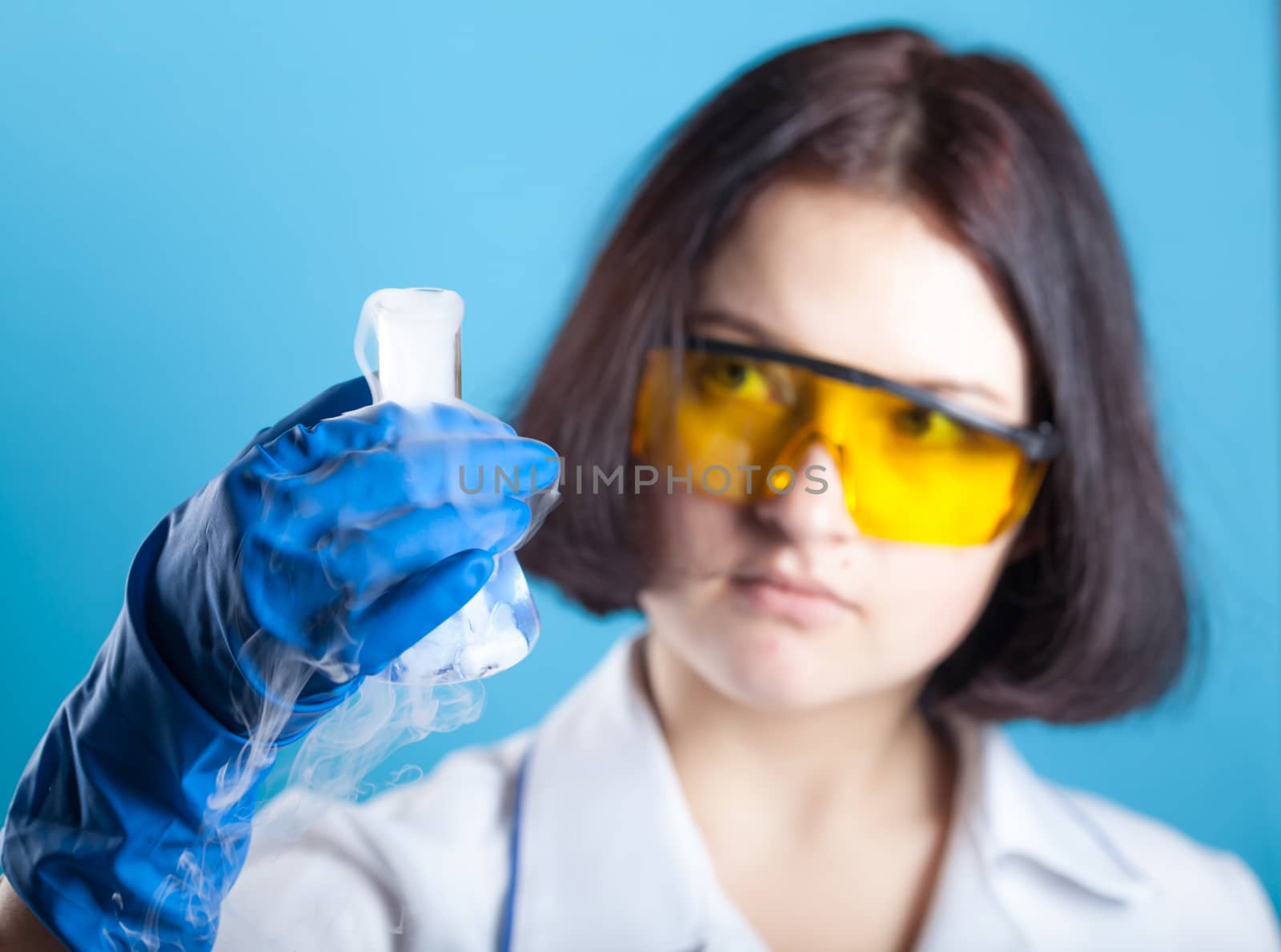 Woman chemist examines test tube  by MegaArt