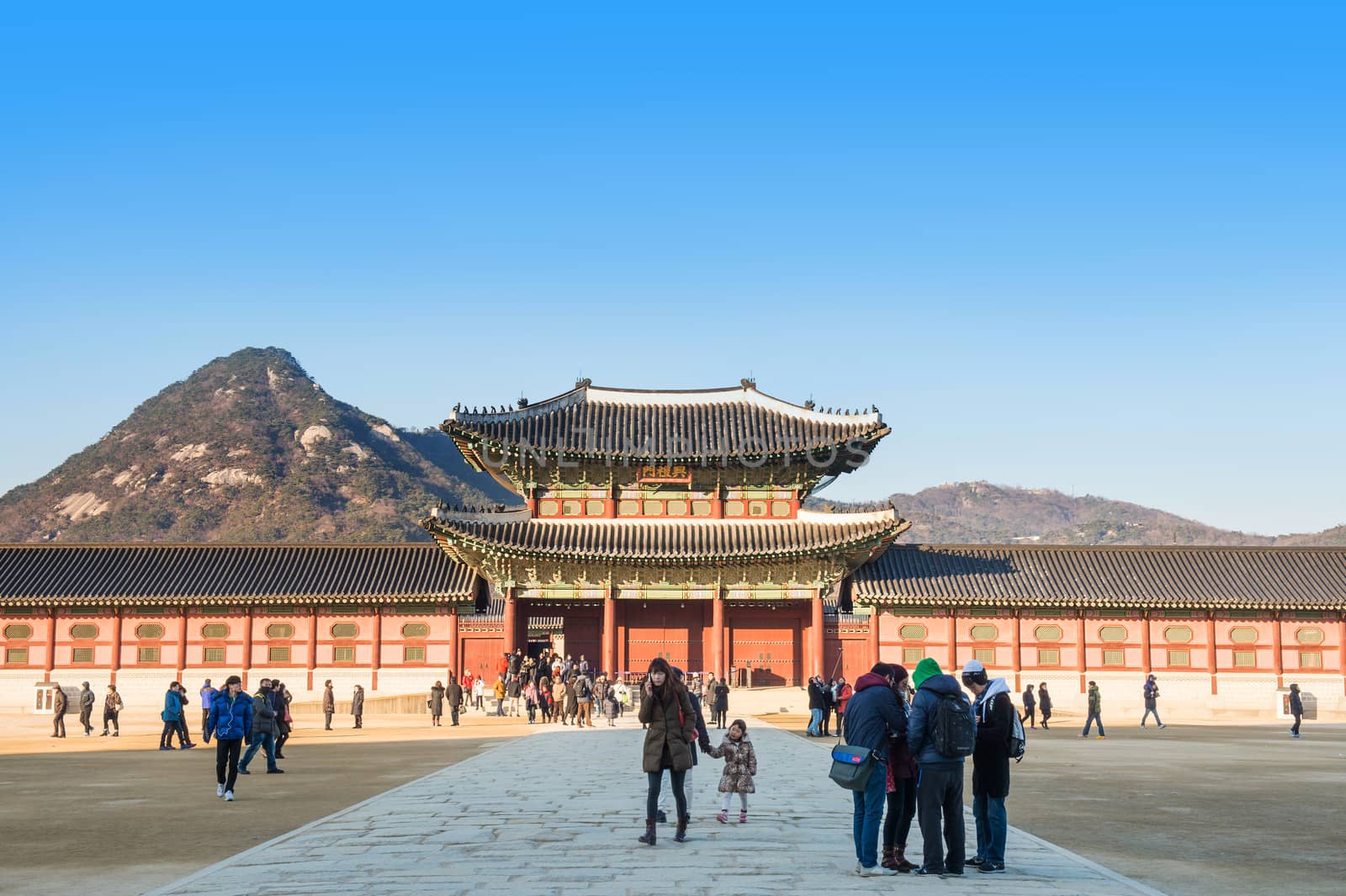 Tourists taking photos of the beautiful scenery around Gyeongbokgung Palace. by gutarphotoghaphy