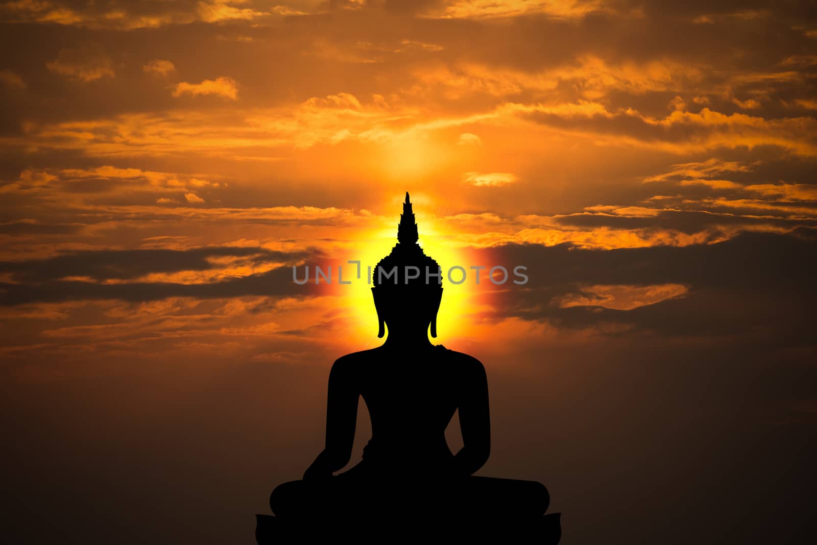 silhouette of buddha and sunset background with blur motion