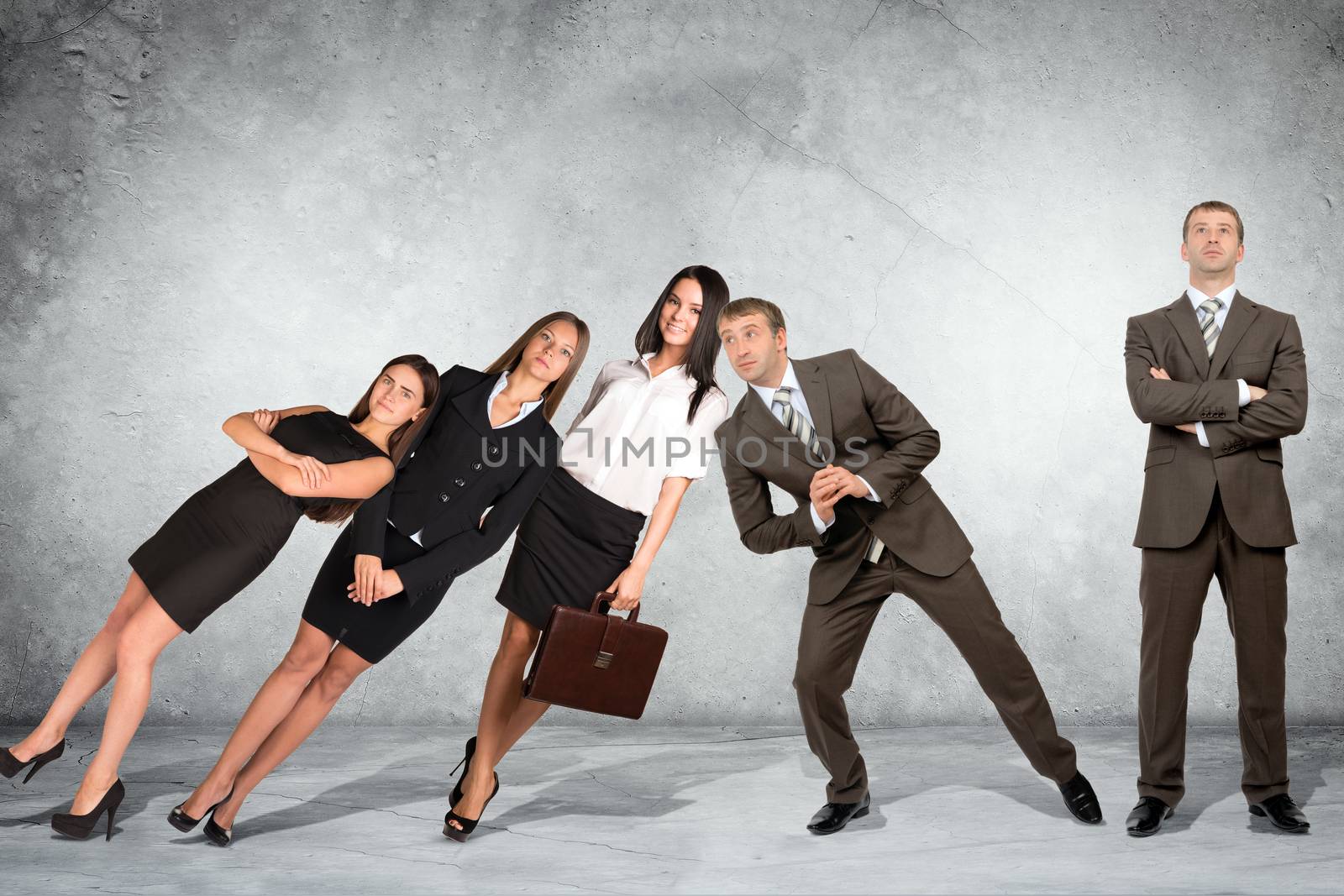 Businessman supporting falling business people on grey wall background, co-working concept