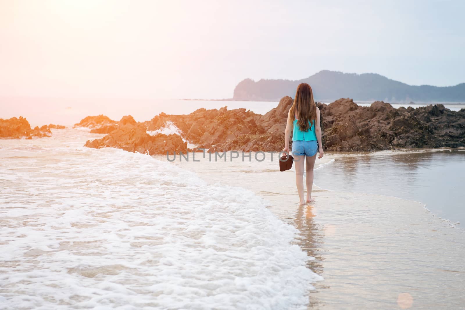 Beautiful girl walking on the beach at sunset by gutarphotoghaphy