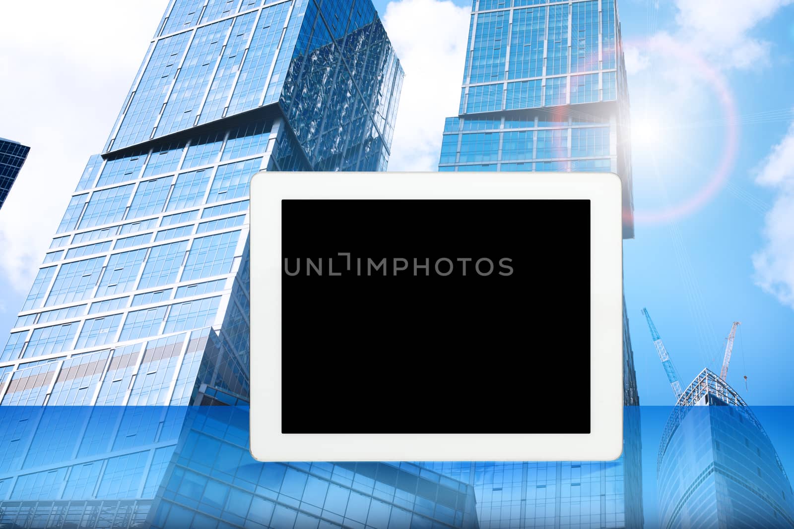 Tablet with blank screen and cityscape background, internet concept