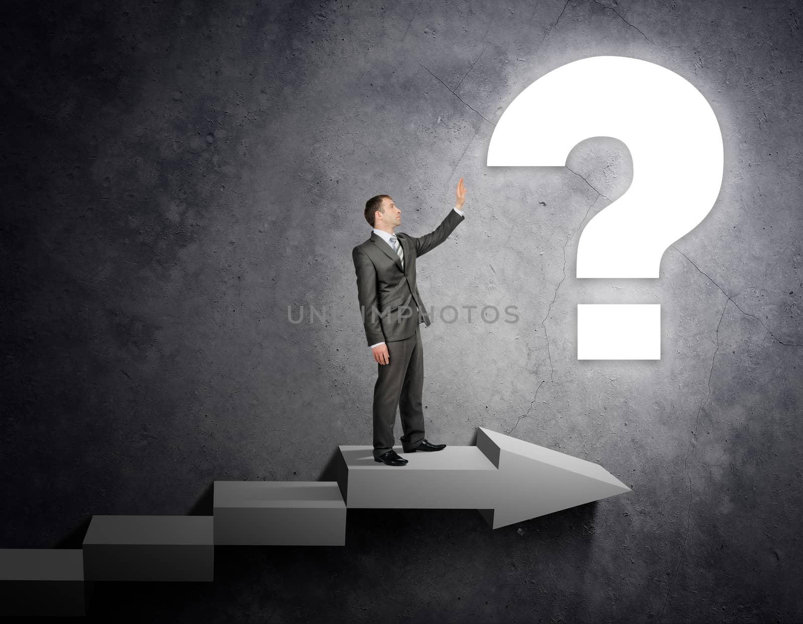 Businessman touching question sign standing on stairs, business concept