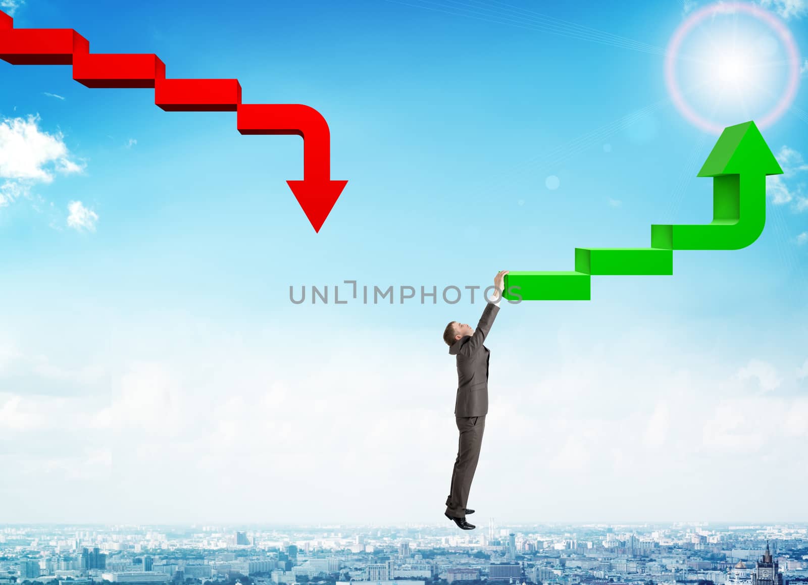 Businessman hanging from green arrow, business concept