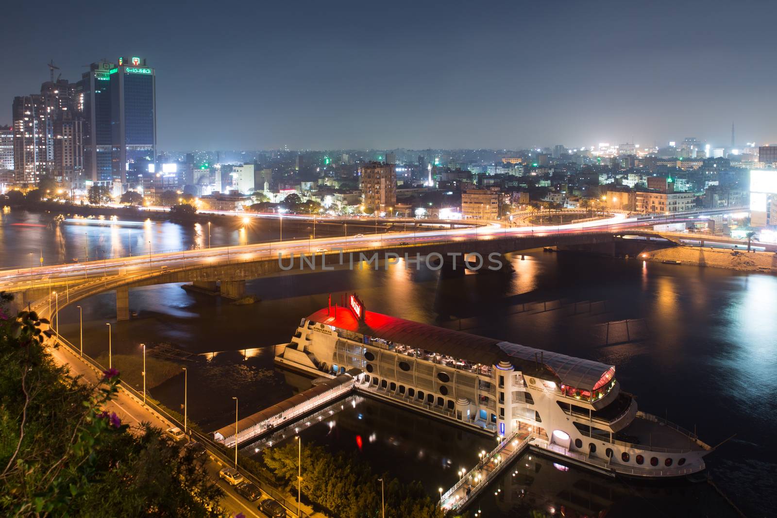 Cairo, Egypt - October 31, 2014: Traffic light trails in Cairo at night, the 15th May bridge, the Nile river and the Corniche Street.