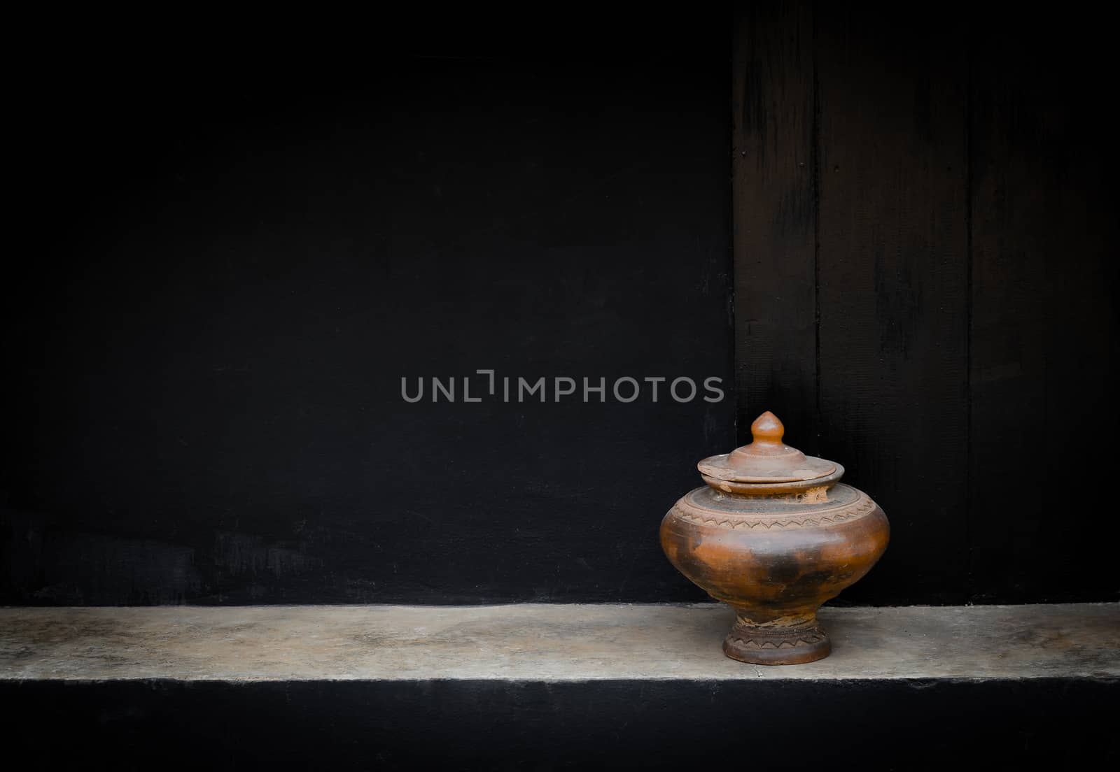 Pottery drinking water jar from northen thailand background