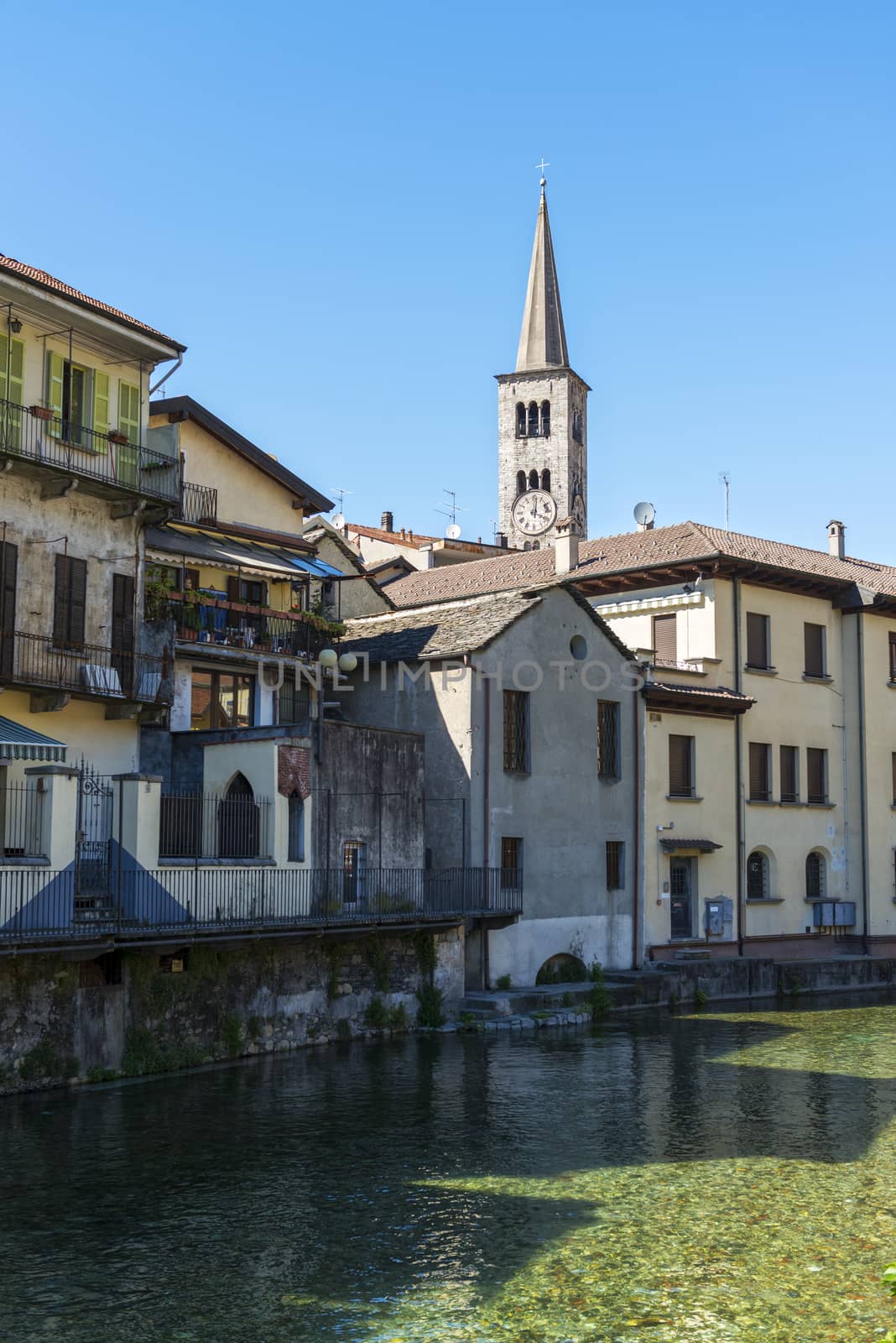 foreshortening of Omegna, between houses and the river with blue sky background - Piedmont, Italy