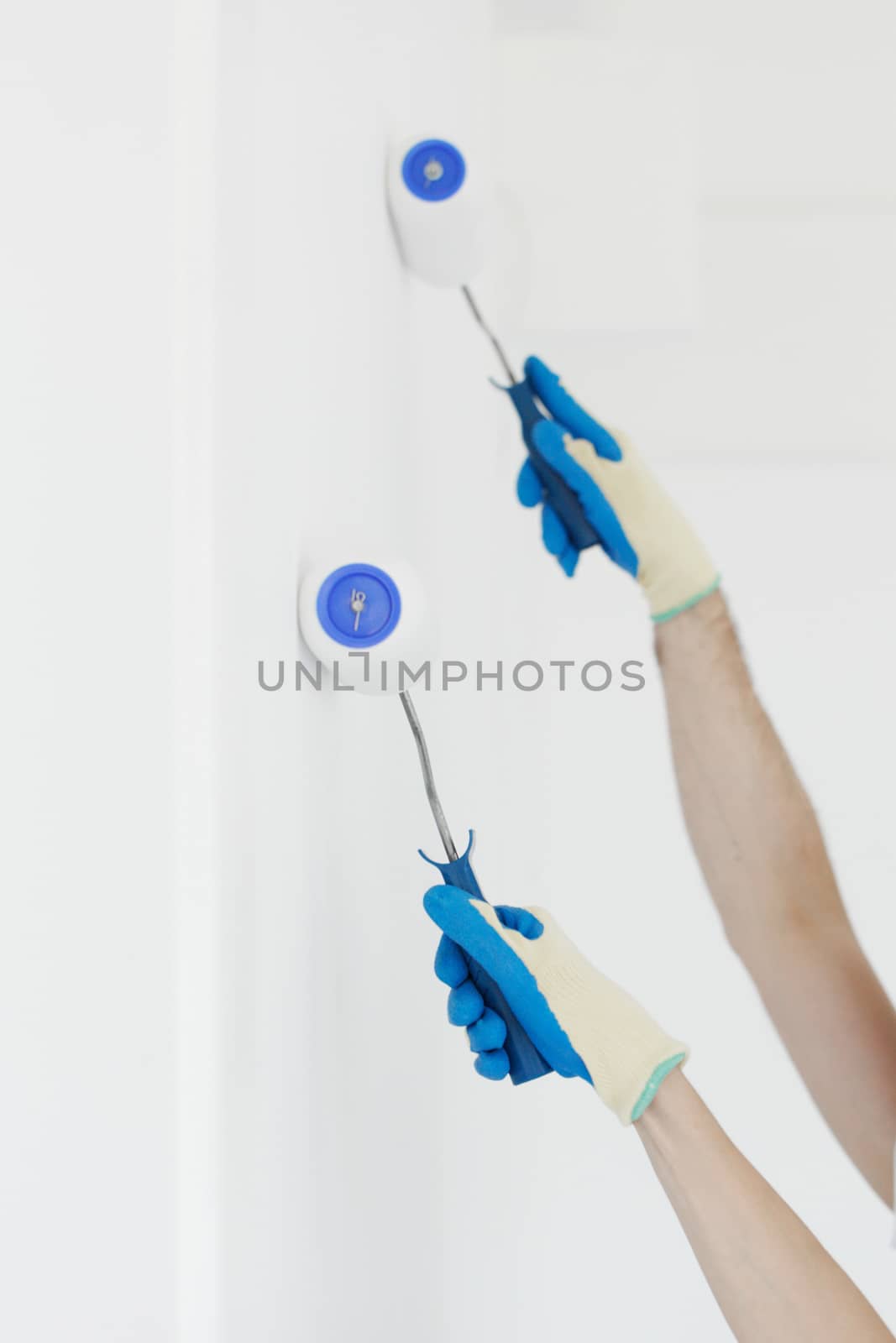 Team of young workers in painting the wall