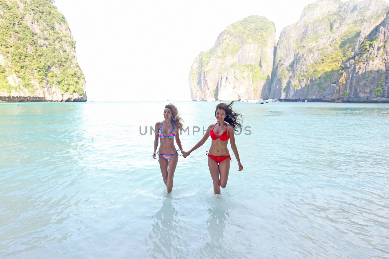 Beautiful women in bikini enjoy sea at Maya bay, Thailand