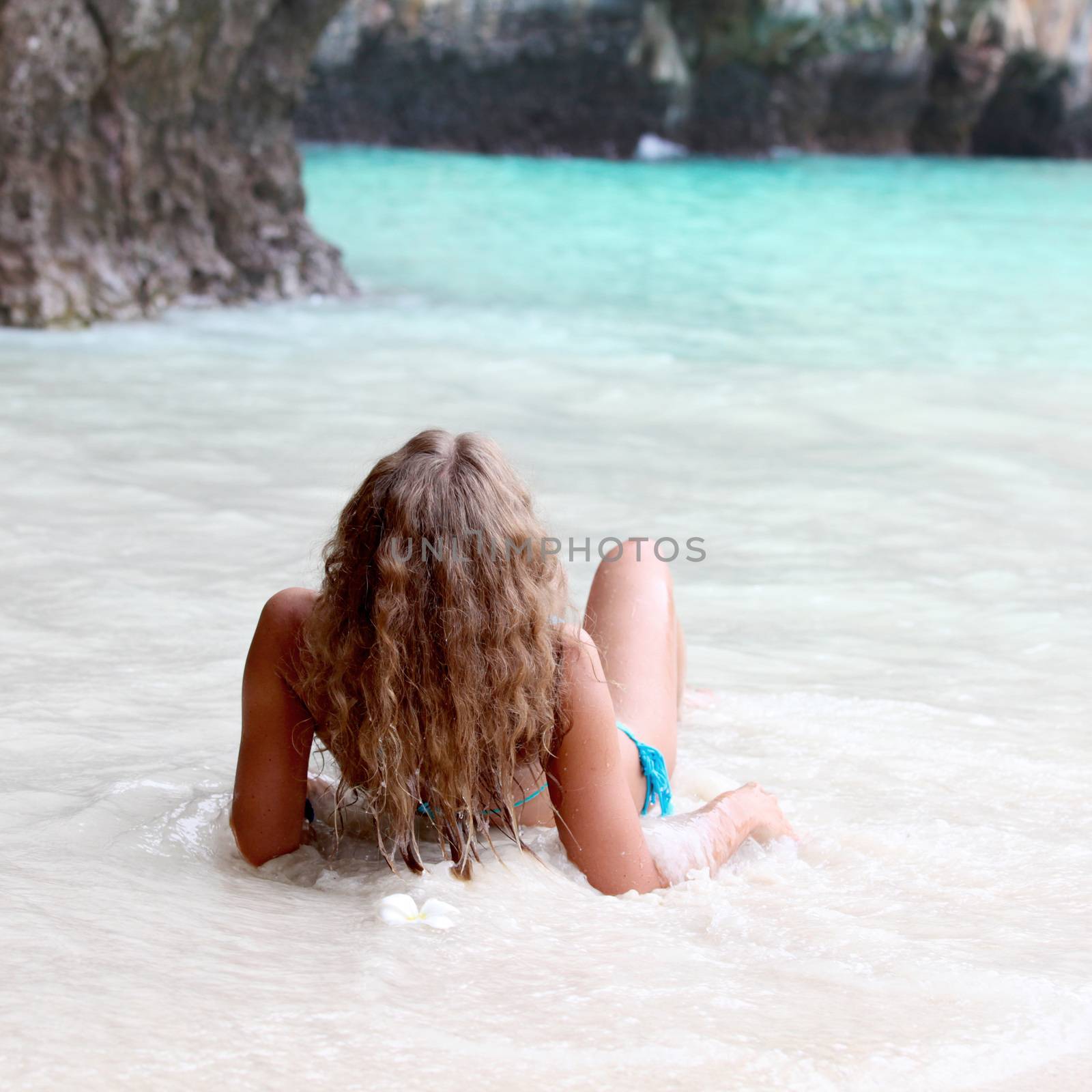 Beautiful woman in thai beach with limestone rocks