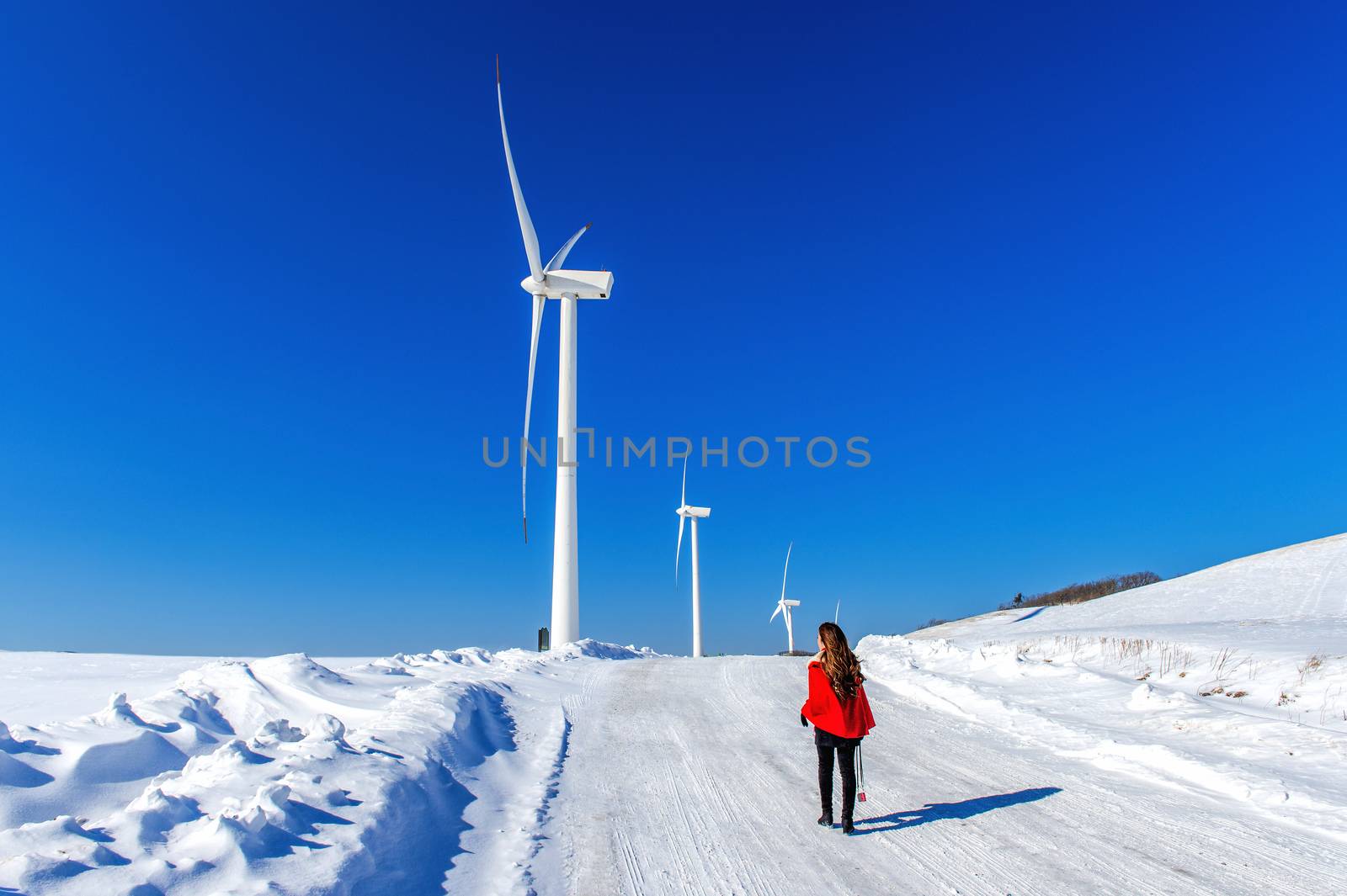 Beautiful girl walking in winter landscape of sky and winter roa by gutarphotoghaphy
