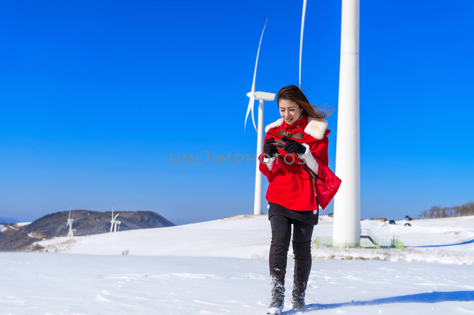 Young woman is a happiness with camera in winter of sky and wint by gutarphotoghaphy