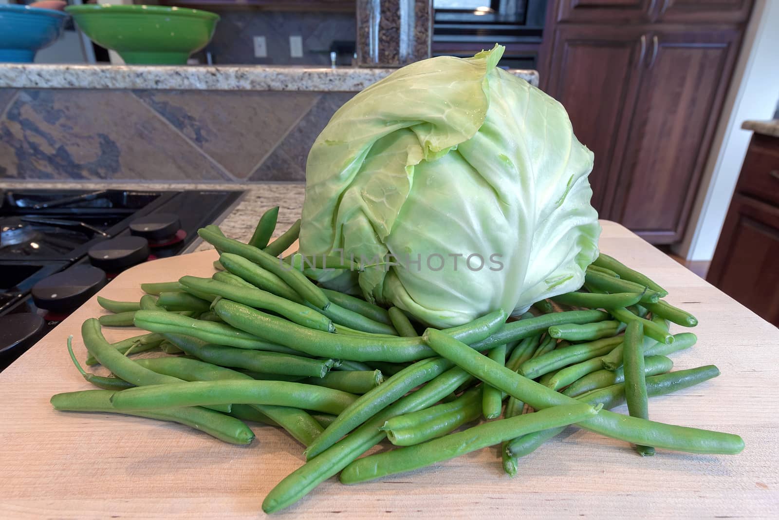 Head of Cabbage and String Beans on Chopping Board by Kitchen Cooking Stove Top