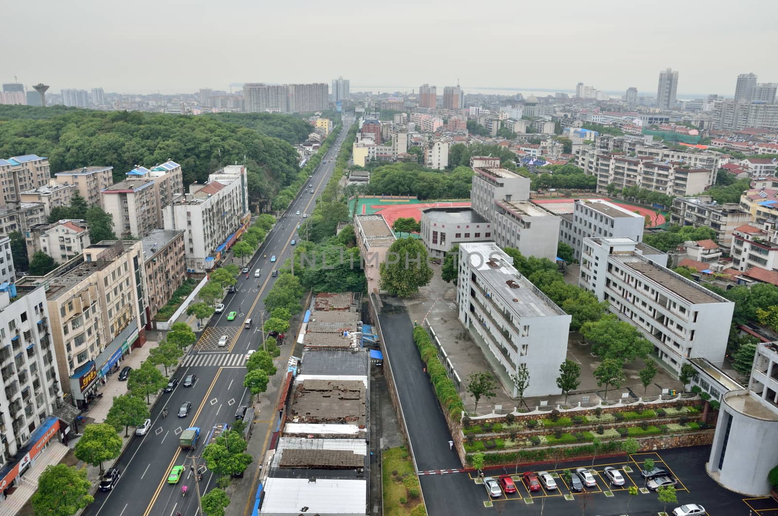 General cityscape of Yueyang city in Hunan province, China. City center with schools, buildings and main street.