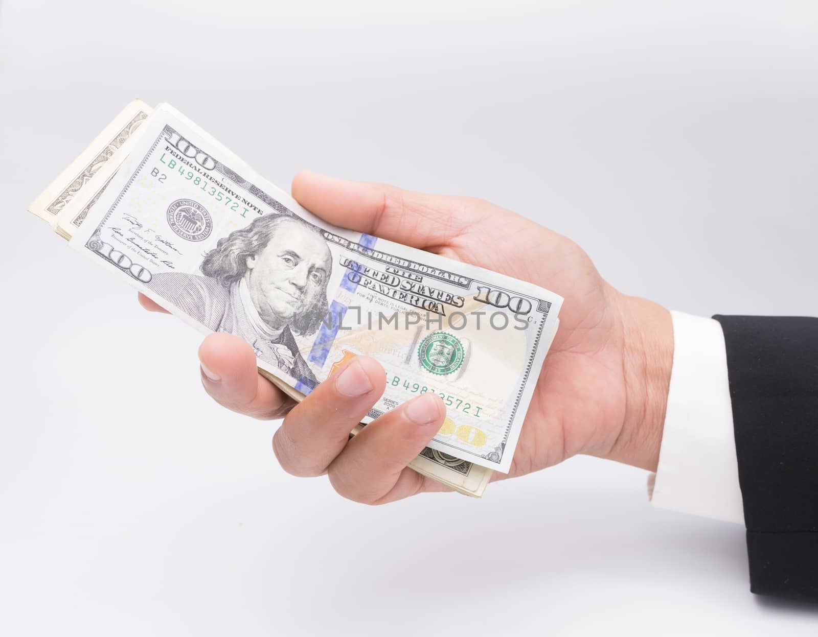 US dollars in business hand isolated on a white background