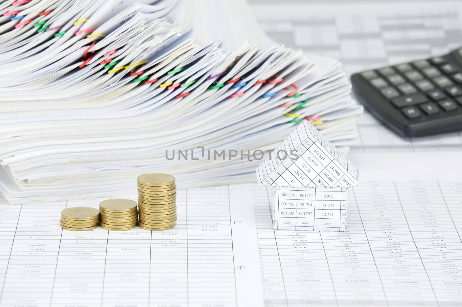 House and step gold coins have overload paperwork as background by eaglesky