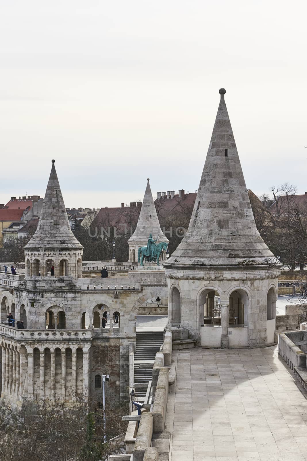 BUDAPEST, HUNGARY - FEBRUARY 02: Cropped shot of Fisherman's Bastion's spires, with statue of Saint Stephen in the background. February 02, 2016 in Budapest.