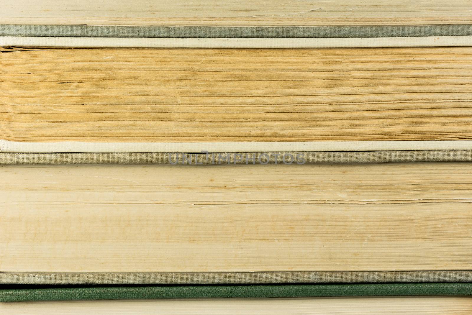 Side view of old antique books as background
