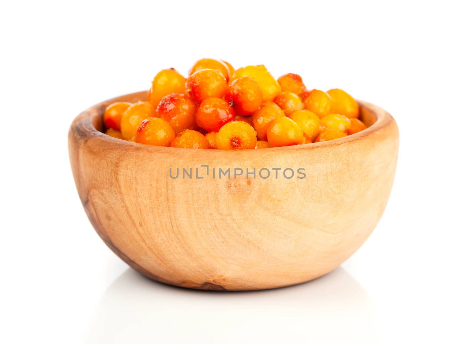 Fresh sea buckthorn berry in a wooden bowl by motorolka