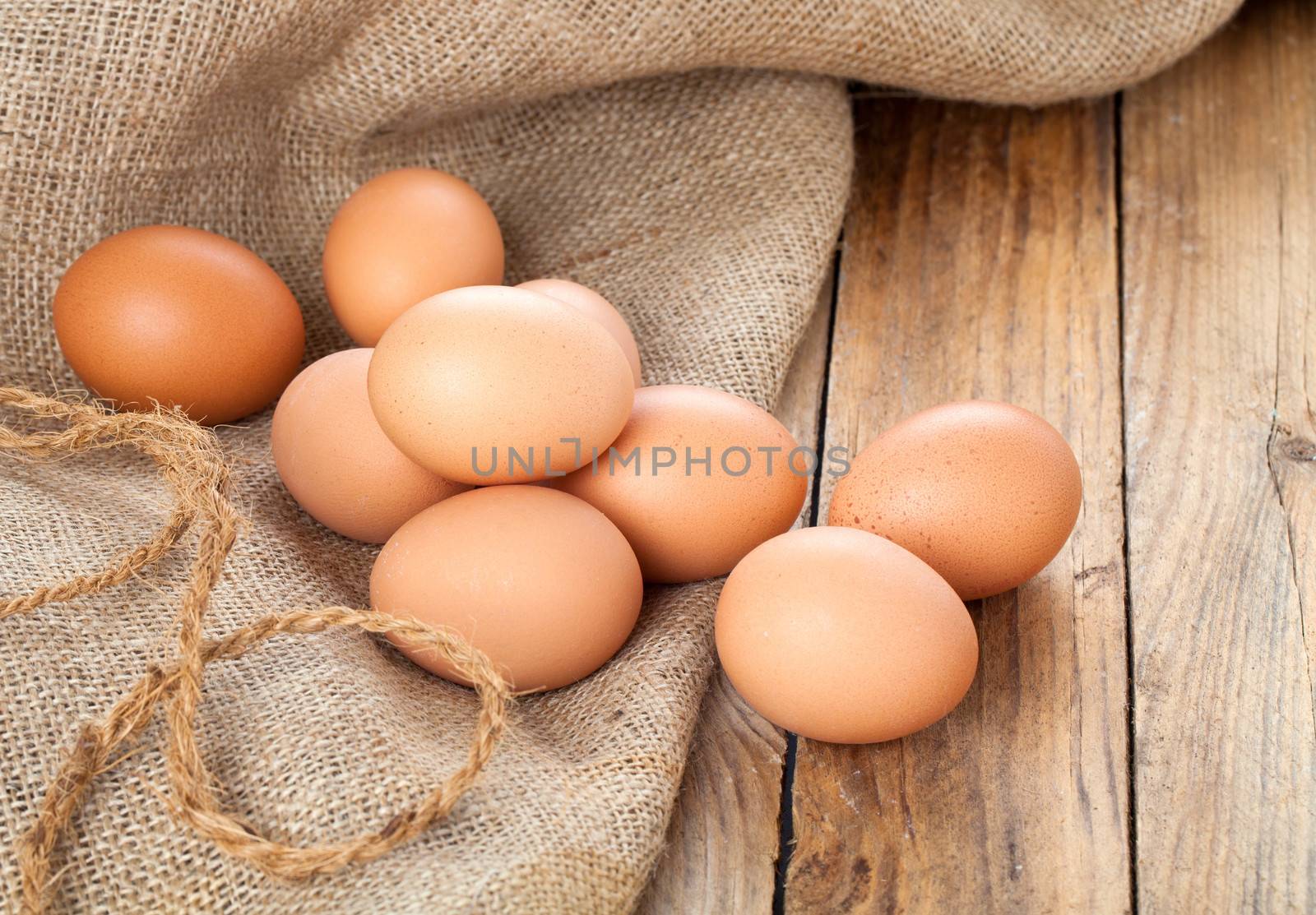 Eggs on wooden background by motorolka