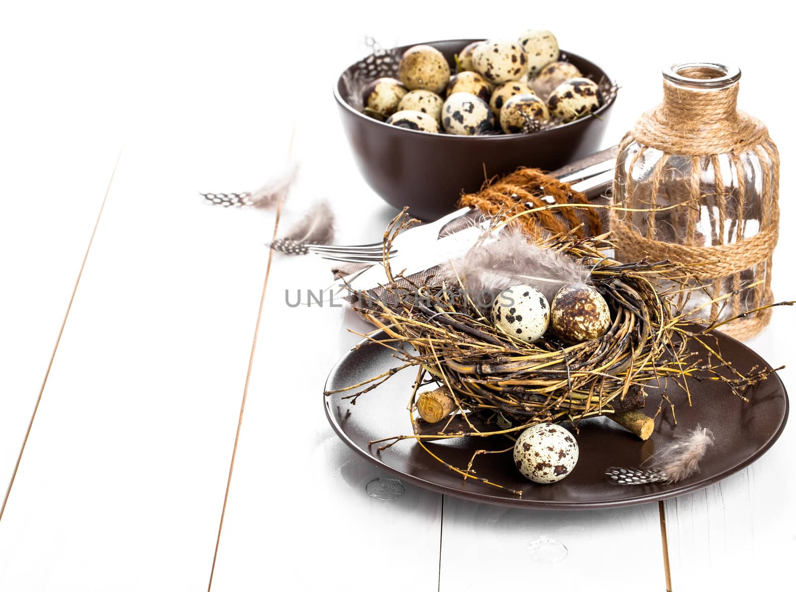 table decoration on white wooden background with quail eggs by motorolka