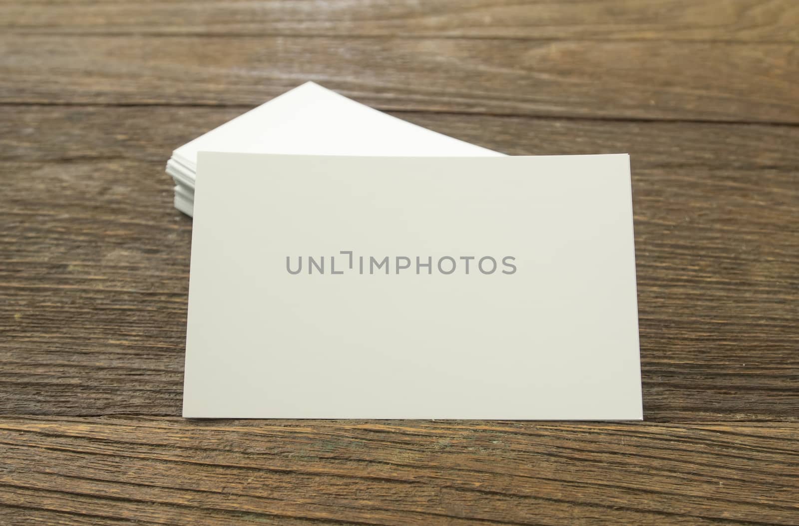 business card placed on a wooden table.