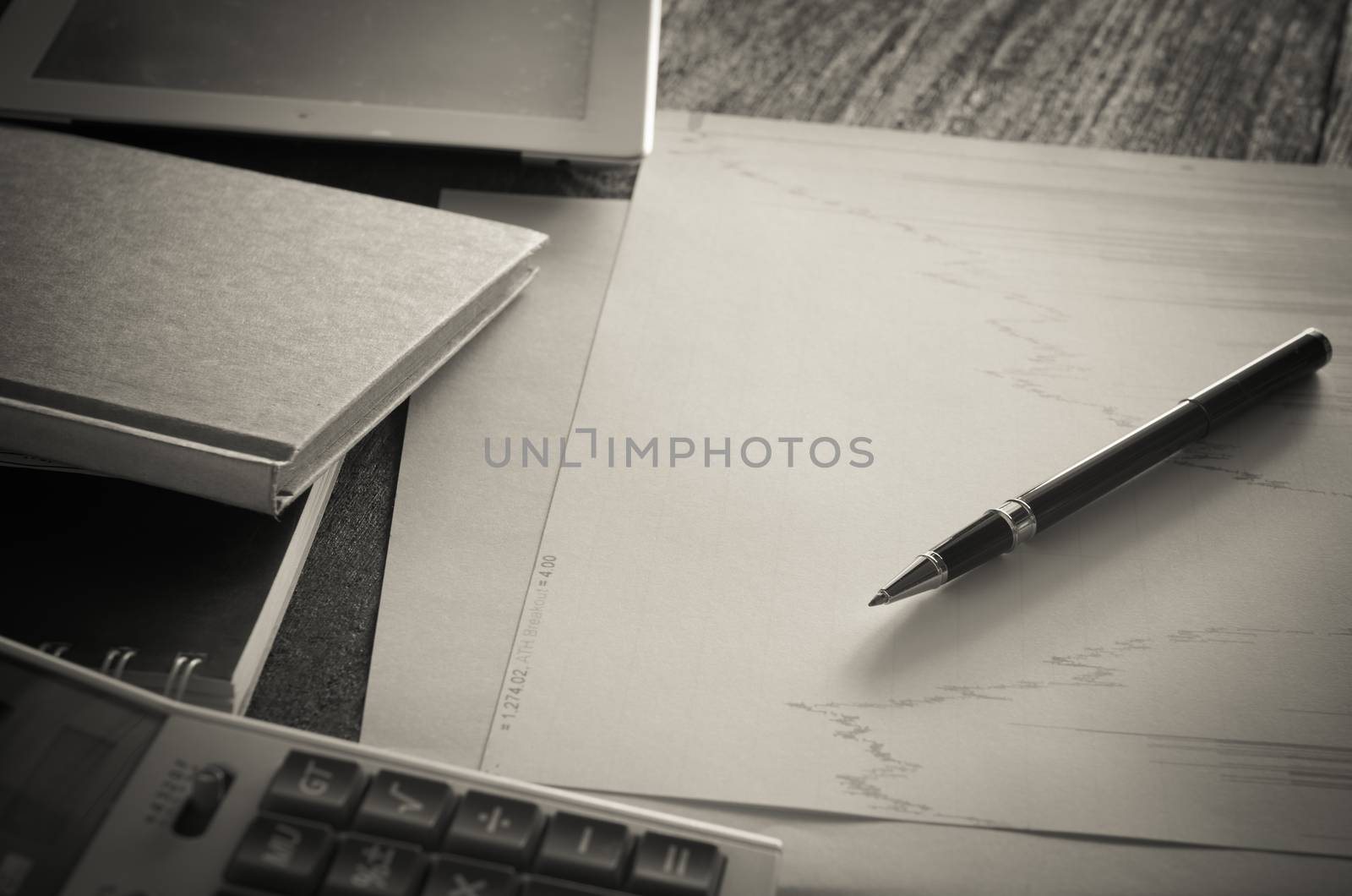 Work table with graph pad and a pen with a calculator.business concept ,style Vintage.