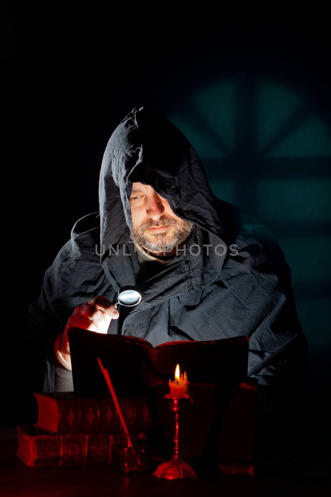 A Monk read mystical occult book in the dark