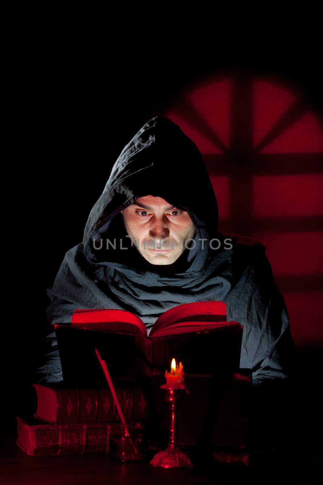 A Monk read mystical occult book in the dark