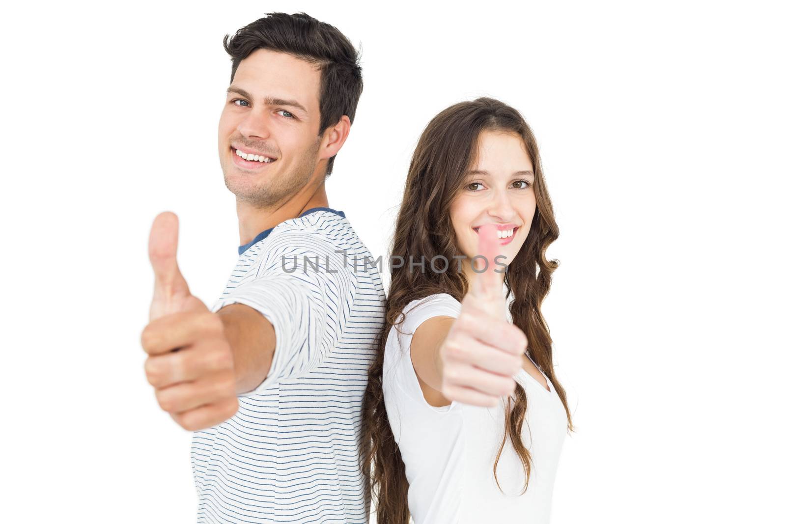 Couple standing back to back with thumbs up by Wavebreakmedia